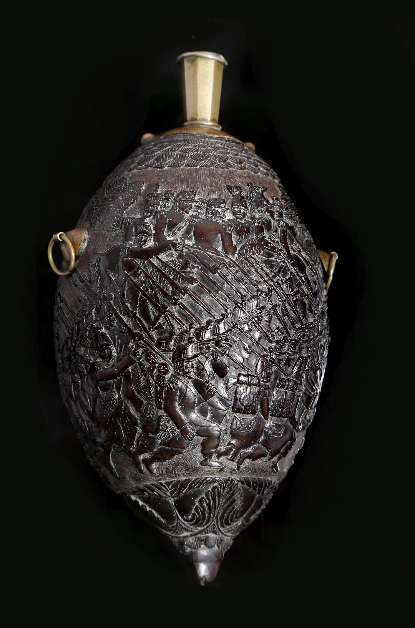 A 19th century French carved coconut bugbear flask, with brass mounts, relief decorated with the - Image 2 of 2