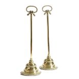 A pair of 19th century brass bell shape doorstops, each with a rope twist handle and a lead weighted