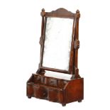 An early 18th century walnut toilet mirror, with a rectangular bevelled plate and turned and block