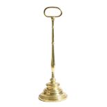 A Victorian brass bell shape doorstop, with a stepped lead weighted base, 47.3cm high.