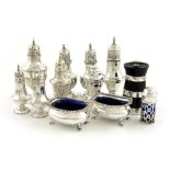 A mixed lot of silver condiments, various dates and makers, comprising: a George III pepper pot,