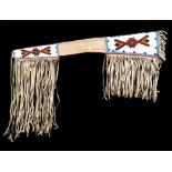 A Blackfoot rifle case buckskin, canvas, coloured glass beads and cloth, of tapering form with