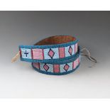 A Blackfoot beaded belt harness leather, coloured glass beads and buckskin, with a central alternate