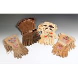 Four pairs of North American gauntlets hide, glass beads and fur, including a Cree pair decorated
