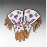 A pair of Blackfoot gauntlets moosehide, coloured glass beads and cloth, with floral designs in