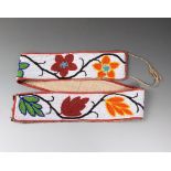 A Chippewa beaded belt coloured glass beads, cloth and buckskin, the white ground with trailing