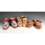 Three pairs of North American moccasins hide, cloth, glass beads and silk thread, including an