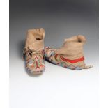 A pair of Blackfoot moccasins buckskin, glass beads, cloth and cotton, with floral beadwork