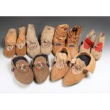 Six pairs of Chippewa moccasins with puckered toes, including four pairs with floral embroidered