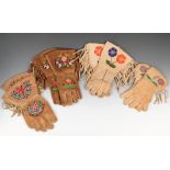 Four pairs of North American gauntlets hide with floral beadwork and side fringes, with printed