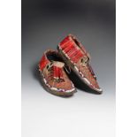 A pair of Sioux moccasins buckskin, quill, glass beads, cotton and tin, with coloured bead