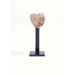 A Mesopotamia calcite lion head protome with an open mouth and part ribbed back, 2.8cm long, on a