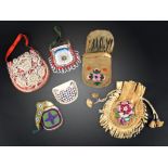 An Iroquois beaded purse with a red cloth and clear glass beads, of a basket and flowers, the back