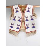 A Yankton Sioux vest circa 1890, buckskin with glass beads, the white ground with blue, yellow and