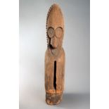 A Vanuatu slit drum Melanesia with an ancestor head finial having a pointed bead coiffure and