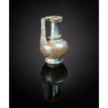 A Roman glass jug circa 3rd - 4th century AD blue/green raised on a spreading foot with a