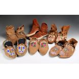 Six pairs of North American moccasins including an Athapaskan pointed toe pair with floral bead