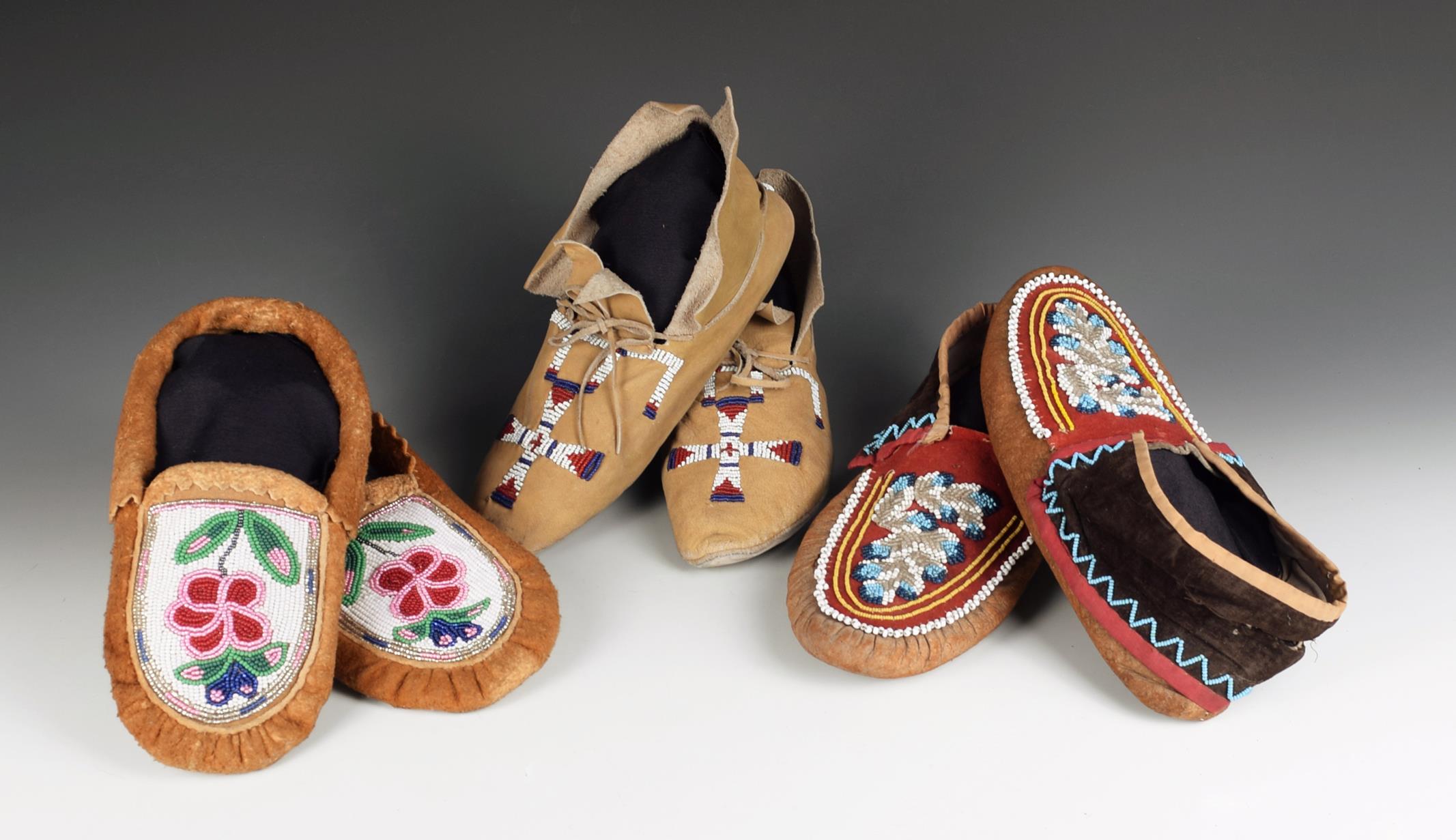 Three pairs of North American moccasins buckskin, glass beads and cloth, including an Iroquois