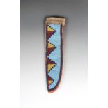 A Blackfoot fully beaded knife sheath canvas, cloth, hide and coloured glass beads, one side with