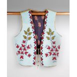 A Plateau area vest circa 1920, buckskin, felt, cotton and beads, the front panels with a