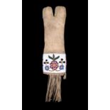 A Cree pipe bag buckskin and coloured glass beads, with floral decorated panels, a long fringe and a