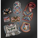 Three Iroquois beaded purses with Niagara floral decoration, the widest 18.5cm, an Iroquois watch