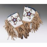 A pair of Blackfoot gauntlets buckskin, coloured glass beads, canvas and cloth, the panelled cuffs