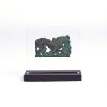 An Ordos bronze belt plaque circa 6th - 5th century BC cast a stylised wolf devouring a deer, the