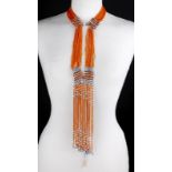 Four South African beaded neck pieces with long fringes, the longest 108cm, and a body ornament with