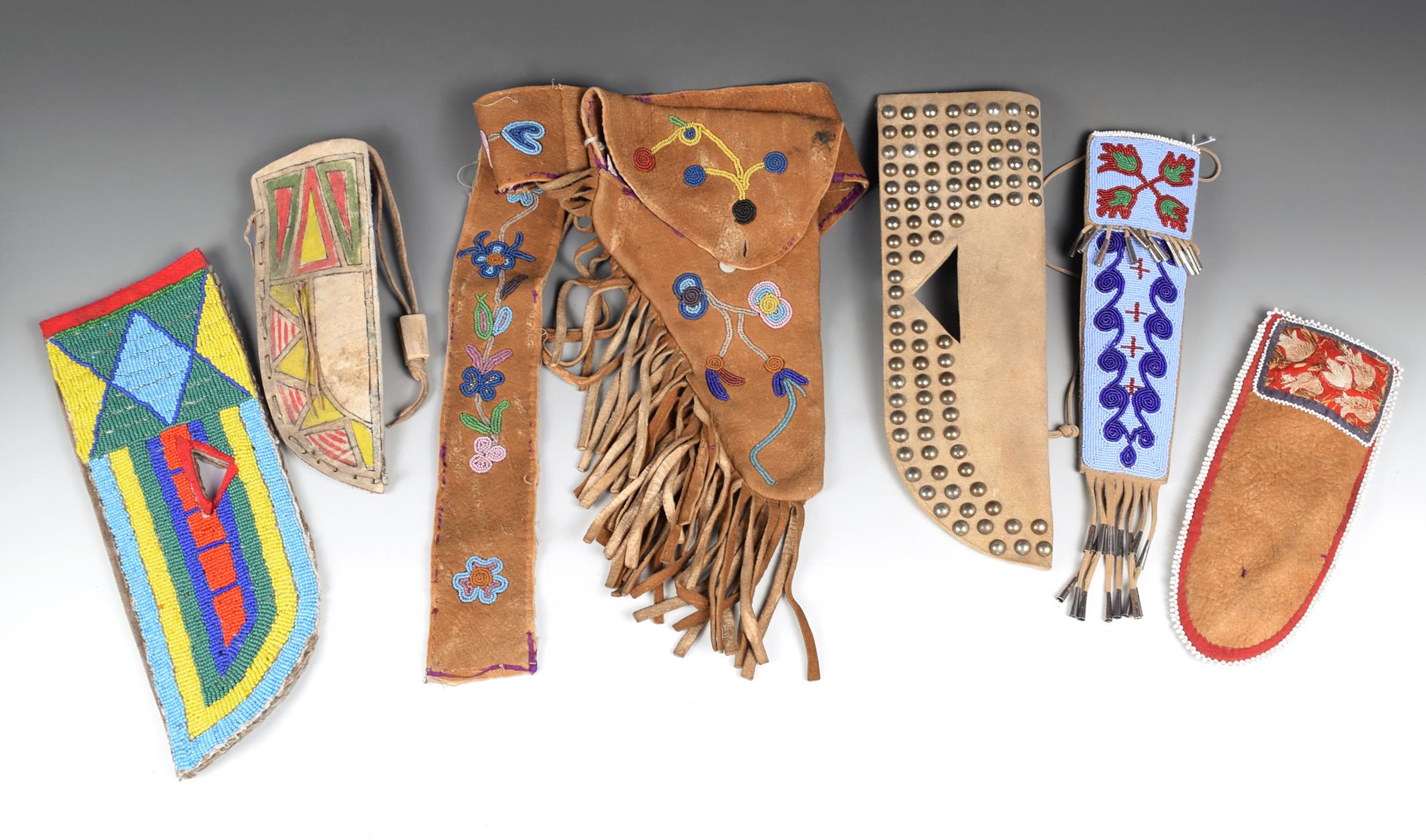 A North American pistol holster and belt buckskin with floral beadwork, the holster with a fringe