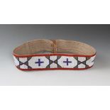 A Northern Plains beaded belt canvas, coloured glass beads, leather and buckskin, with a white