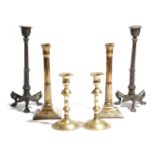 A pair of late 19th century French bronze candlesticks, the nozzles decorated with a warrior on