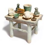 A Chinese pottery altar in Han Dynasty style, together with part glazed pottery offerings,