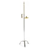 A brass and wrought iron adjustable candlestand, with an urn finial above an adjustable sconce, with