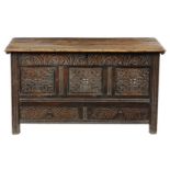 An early 18th century oak mule chest, the interior with a lidded till, the triple panelled front