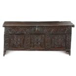 A 17th century elm six plank coffer, the hinged lid with a moulded front and grooved sides,