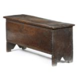 A small early 17th century six plank coffer, the hinged top with a moulded front edge and grooved