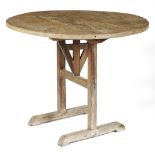 A French oak country wine tasting table or vendange table, the circular boarded top on sleigh