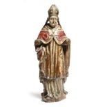 A continental carved wood and polychrome decorated figure of a bishop, with parcel gilt