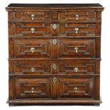 A Charles II oak chest, in two parts, with two short and four long geometric panelled front drawers,