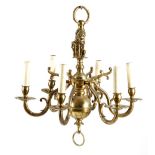 A Dutch brass six-light chandelier in 17th century style, the stem with a lion holding a coat of