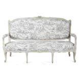 A French white painted canapé in Louis XVI style, the padded back, seat and armrests covered in en