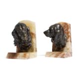 After Prosper Lecourtier (French 1851-1924). A pair of onyx and bronzed spelter bookends, each