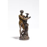 An early 19th century bronze group, of a scantily clad young shepherd holding a lamb, standing on