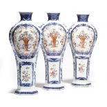 A set of three Chinese porcelain famille rose flattened baluster vases, with underglaze blue