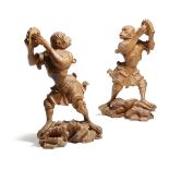 A pair of Italian Rococo style carved pine models of dancing monkeys, each playing the tambourine