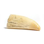 A 19th century sailor's scrimshaw whale's tooth, decorated to one side with a twin-masted sailing