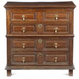 A late 17th century oak chest, in two halves, with two short and three long panelled drawers, with