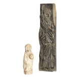 A Medieval style sandstone figure of a female saint, wearing a cloak and holding something in her