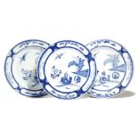 A set of three Chinese porcelain blue and white shallow dishes, painted with a bird in the house